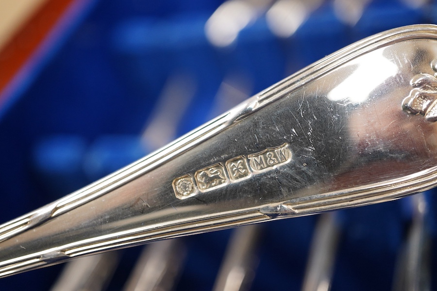 An Elizabeth II canteen of silver cutlery for eight, by Mappin & Webb, comprising table and dessert forks, dessert, soup and teaspoons, silver handled steel table and dessert knives two table or serving spoons and a pair